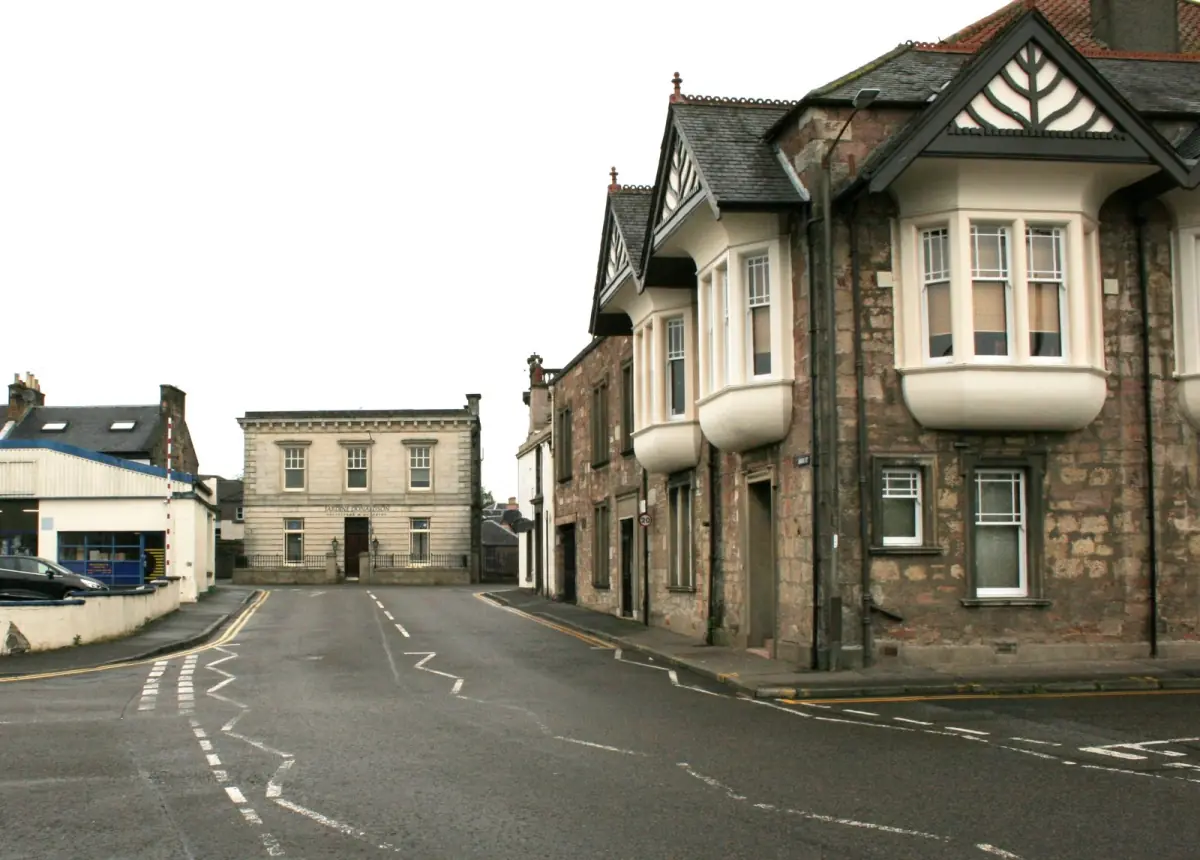 Union Street in Alloa with stone buildings and a bay-windowed corner house