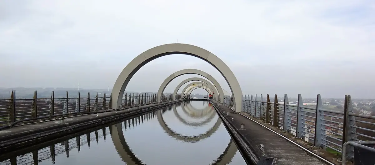 Half-rings of the Falkirk Wheel reflected in the still approach canal