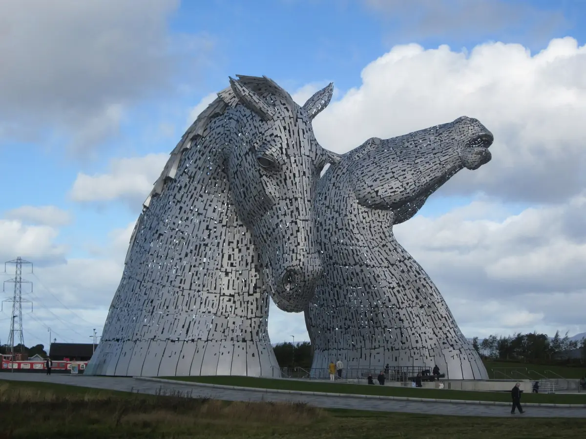 The two steel Kelpies horse heads at Helix Park under blue sky