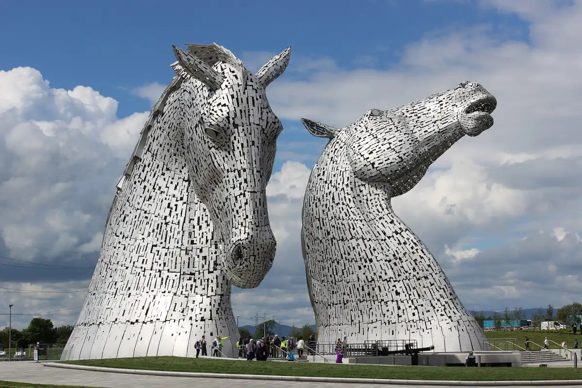 The Kelpies sculptures standing side by side beneath white clouds