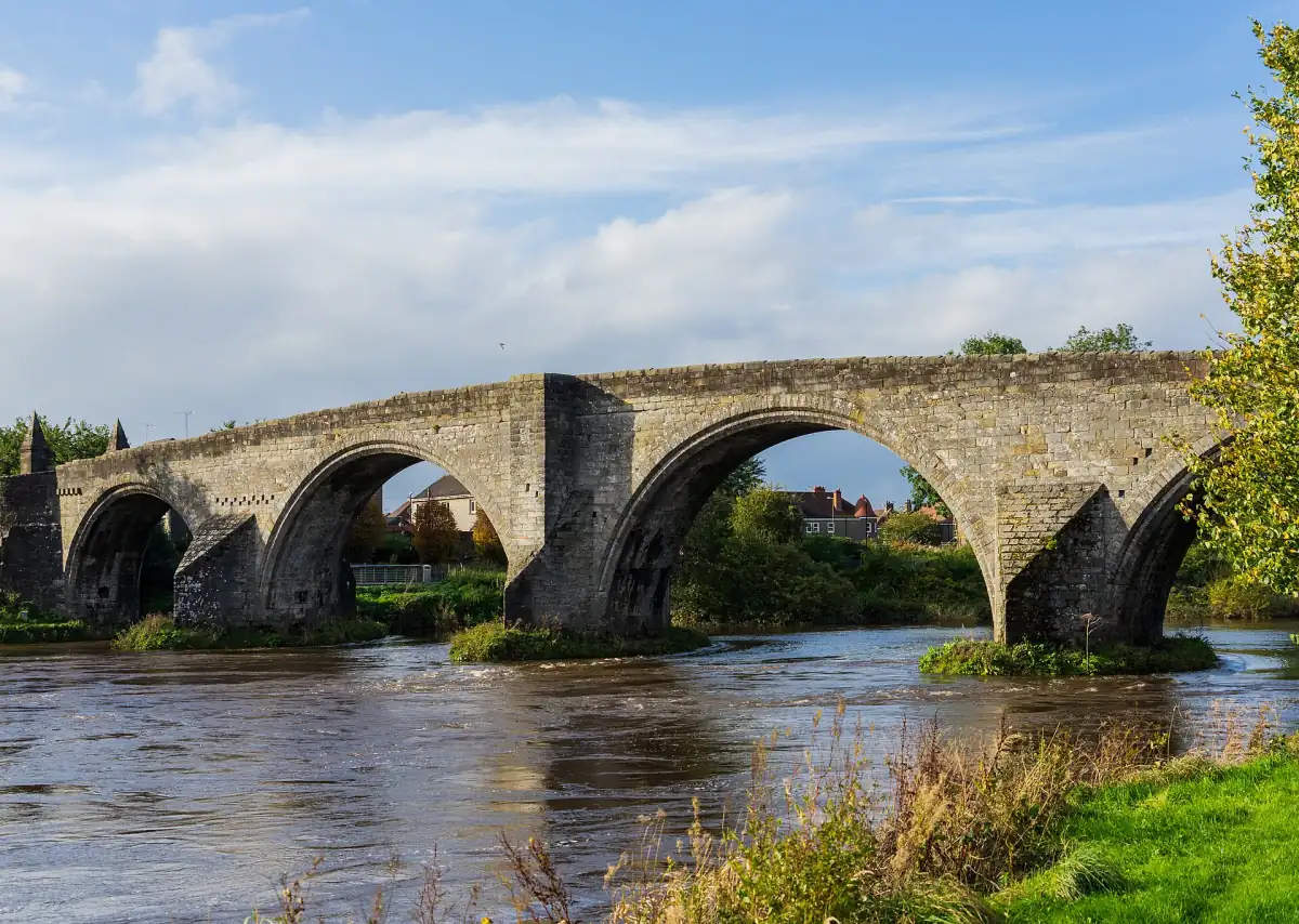 Stirling Old Bridge with its stone arches over the River Forth in sun